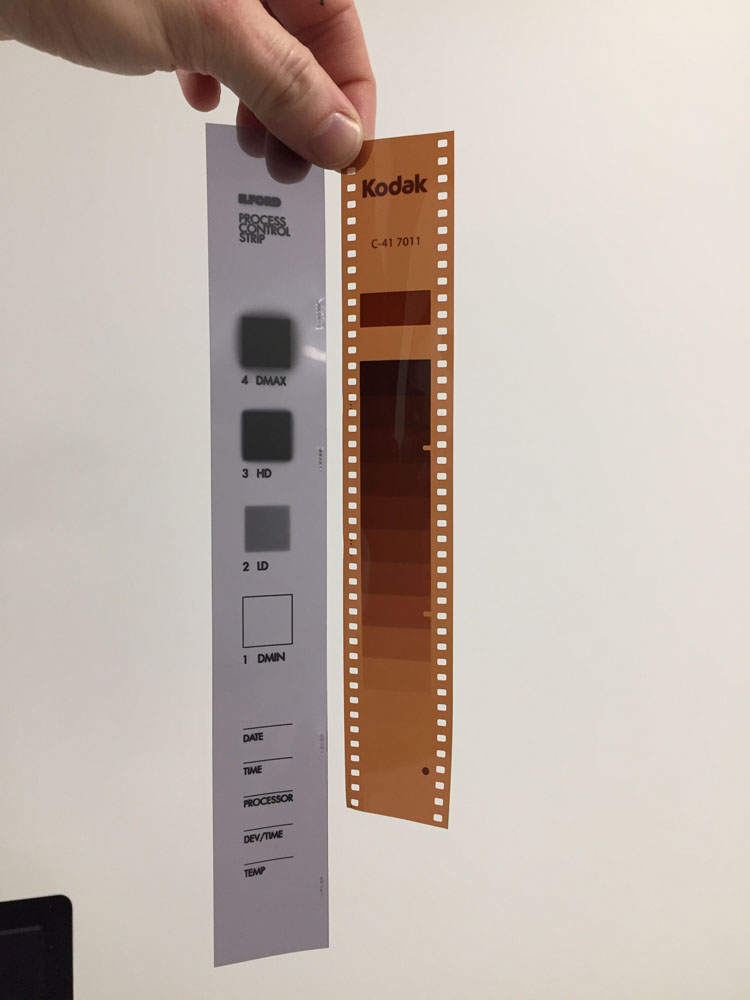 A Kodak process control strip held up to the light